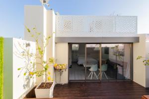 a house with a glass door leading to a bedroom at Minty Stay - La Merced Atico Duplex in Málaga