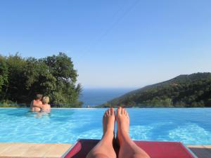 a person laying on the edge of a swimming pool at Agriturismo Villa Lupara in Salerno