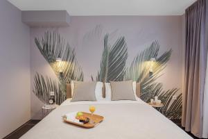 a bed with a tray of food and drinks on it at VISIONAPARTMENTS Neustadtstrasse - contactless check-in in Luzern