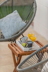 a tray with two glasses of orange juice on a table at Villa Novak in Čilipi