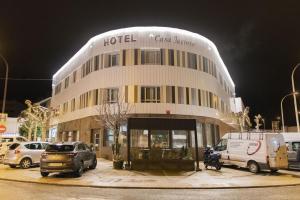 a hotel building with cars parked in front of it at Hotel Casa Jacinto Pamplona in Burlada