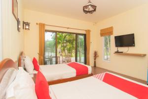 Llit o llits en una habitació de OYO 607 Nawang Resort