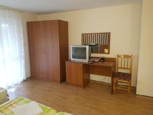 a room with a desk with a computer and a tv at Hotel Zora in Velingrad