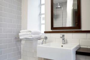 a white sink sitting under a mirror in a bathroom at Ravensworth Arms by Chef & Brewer Collection in Gateshead
