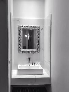 a bathroom with a sink and a mirror at Omiros in Faliraki