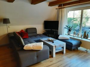 a living room with a couch and a table at Ferienhaus Kerstin in Lindow