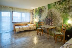 a bedroom with a bed and a table and chairs at Monteurzimmer Linde in Limbach