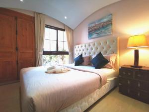 1 dormitorio con 1 cama blanca grande y ventana en D14 Venetian Condo Resort Pattaya Pool Connected Netflix en Jomtien Beach