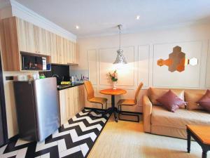 a kitchen and a living room with a couch and a table at D14 Venetian Condo Resort Pattaya Pool Connected Netflix in Jomtien Beach