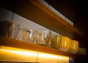 a shelf with glasses and a lemon on it at Church Lane Holiday Home, Warrenpoint in Warrenpoint