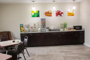 a kitchen with a counter and a table and chairs at Quality Inn in Sawyer