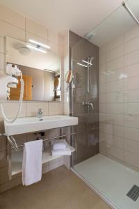 a bathroom with a sink and a shower at Domaine A Marella in LʼÎle-Rousse