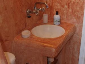 a bathroom with a wooden sink with a bottle of soap at Villa Petradi (150 meters from the sea) in Ambelas +75 photos