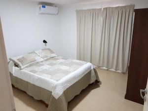 a bedroom with a bed and a window at CENTRO RENT APART in Federación