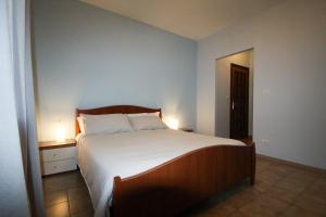 a bedroom with a large bed with two lamps on it at AceroRosso B&B in Salerno