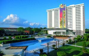 a hotel with a pool in front of a building at Margaritaville Lake Resort, Lake Conroe in Montgomery