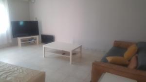 a living room with a couch and a table at Kololi 2 Bed room Apartment in Kololi +3 photos
