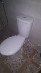 a bathroom with a white toilet in a room at Kololi 2 Bed room Apartment in Kololi