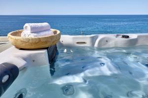 a bath tub with a bowl of towels in the water at Castello Village Resort in Sisi