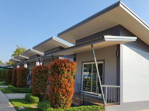 a house with a staircase in front of it at Maharak Resort in Nong Khai