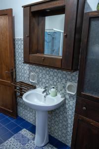 a bathroom with a white sink and a mirror at Il Fenicottero Guest House in Campofelice di Roccella