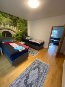 a living room with two beds and a painting on the wall at Wohnen auf Zeit in Essen in Essen