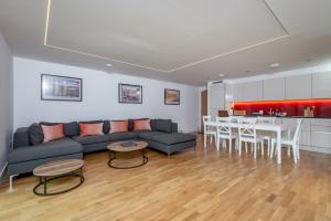 a living room with a couch and a table at Luxury Apartment with Garden, and Putting Green in St. Andrews