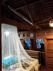 a bedroom with a bed with a mosquito net at Antonio's ko yao noi BED & Pool in Ko Yao Noi