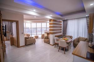Mus Grand Hotel في موش: غرفة معيشة مع طاولة وكراسي