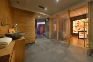 a bathroom with a stone sink and a shower at Hotel St. Michael in Livigno