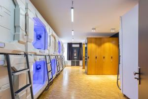 a hallway with blue and white machines in a room at Spacehotel Karlsruhe in Karlsruhe