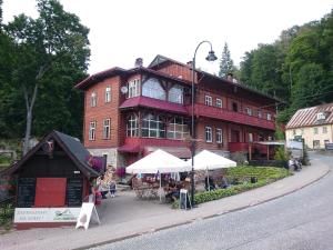 a large red building with a market in front of it at Apartament Dobry klimat in Miedzygorze