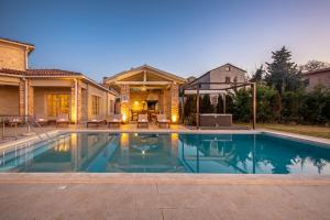 a swimming pool in the backyard of a house at Villa Star in Vižinada