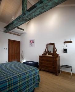 Postel nebo postele na pokoji v ubytování Agriturismo Erbaluna