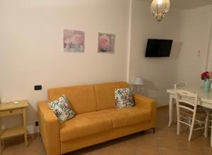 a living room with a brown couch and a table at Appartamento "Magnifica vista sul mare" in Nebida