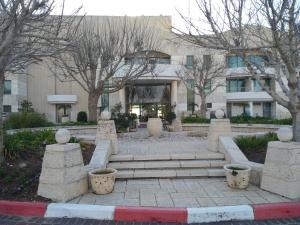 a building with trees and stairs in front of a building at Shoresh mountain in Shoresh