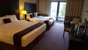 Katil atau katil-katil dalam bilik di Shamrock Lodge Hotel