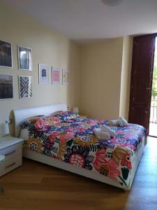 ein Schlafzimmer mit einem Bett mit einer bunten Bettdecke in der Unterkunft FORT.Montagna A106 in Rivisondoli