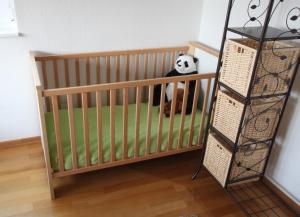a crib with a panda bear sitting in it at Ferienhaus Vera in Moritzburg