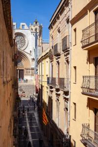 una calle de la ciudad con una torre del reloj y un edificio en Beautiful Apartment in Abat Street by Batuecas en Tarragona