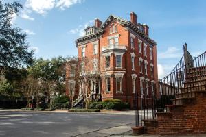 a red brick building with a staircase in front of it at Kehoe House, Historic Inns of Savannah Collection in Savannah