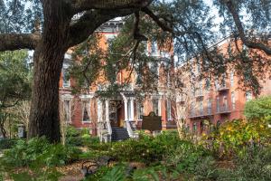 a red brick building with a tree in front of it at Kehoe House, Historic Inns of Savannah Collection in Savannah