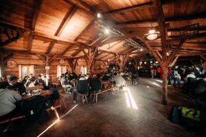a group of people sitting at tables in a restaurant at Munich Oktoberfest ESN Campsite with Breakfast! in Munich