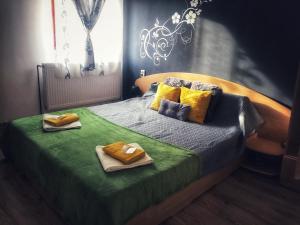 a bedroom with a bed with two towels on it at CasaMaria in Slănic-Moldova
