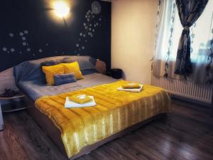 a bedroom with a bed with two towels on it at CasaMaria in Slănic-Moldova