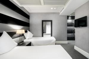 Postel nebo postele na pokoji v ubytování Hotel Mancino 12