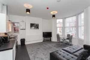 a kitchen and living room with a couch and a table at Cherry Property - Berry Apartments in Blackpool