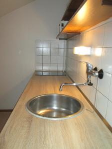 a stainless steel sink in a counter in a room at Penzion U Holubů Nový Jičín in Nový Jičín