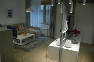 a living room with a couch and a table at SLAVNA - Luxe & Wine by the Fortress in Belgrade