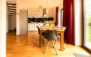 a kitchen and dining room with a wooden table and chairs at Quiet Nature Near Cologne 2 in Bergisch Gladbach